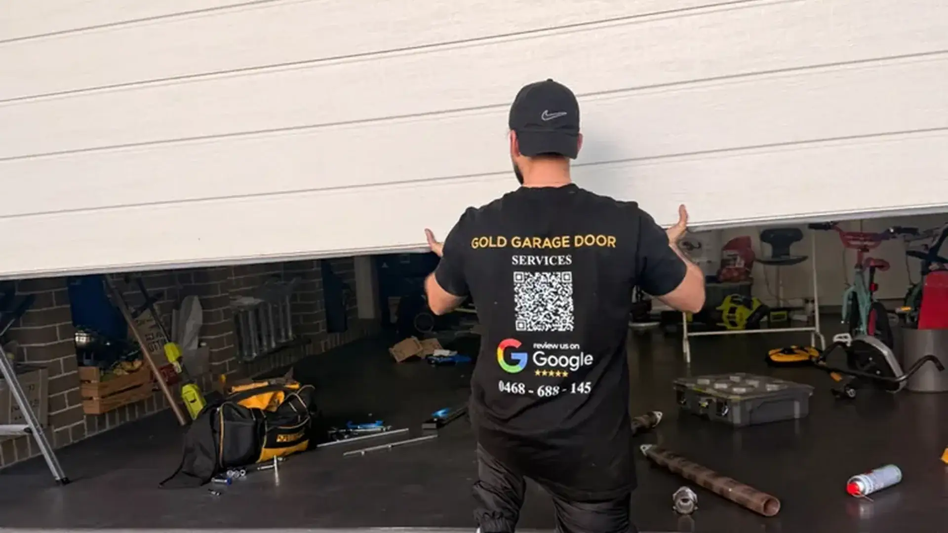 Gold Garage Door technician repairing a residential garage door in Sydney